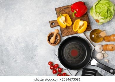 Frying pan. Empty non-stick frying pan and kitchen utensils set on textured wooden background. cooking concept. Top view. Space for text. Flat lay. Recipe.