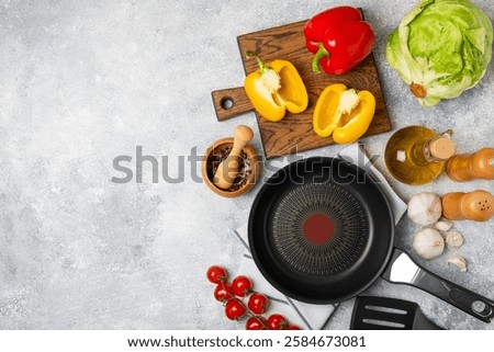 Frying pan. Empty non-stick frying pan and kitchen utensils set on textured wooden background. cooking concept. Top view. Space for text. Flat lay. Recipe.