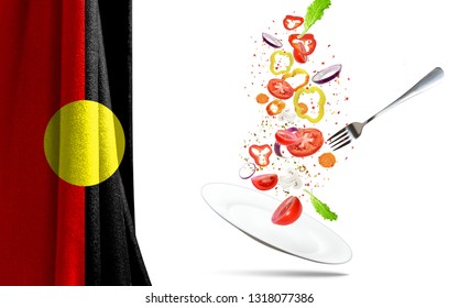 Frying Pan With Falling Vegetables, Isolated. On The Background Of The Flag Of Australian Aboriginal