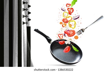 Frying pan with falling vegetables, isolated. On the background of the flag of Brittany