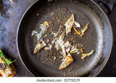 Frying Pan With The Leftovers Of A Fried Fish