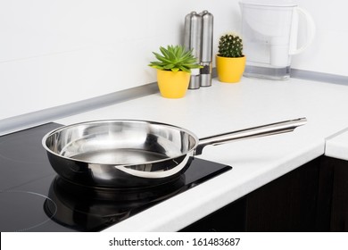 Frying Pan In Modern Kitchen With Induction Stove