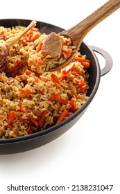 Frying Pan With Tasty Asian Pilaf On White Background