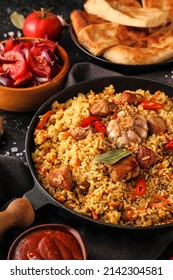 Frying Pan With Tasty Asian Pilaf On Table