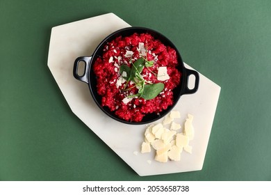 Frying pan with tasty beet risotto on color background