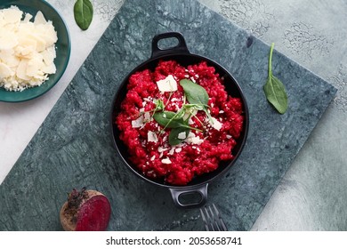 Frying pan with tasty beet risotto on table