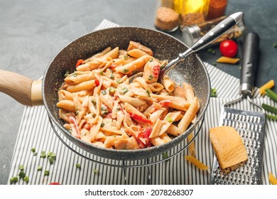 Frying Pan With Tasty Cajun Chicken Pasta On Color Background, Closeup