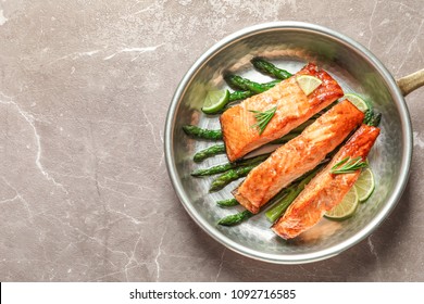 Frying Pan With Tasty Cooked Salmon On Table, Top View