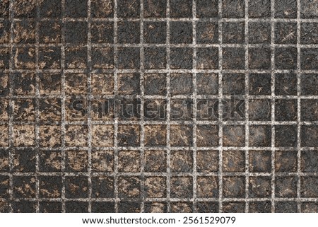 Frying pan texture. The surface of old cooking pan, closeup. Background, texture, top view of a black pan with a checkered pattern.