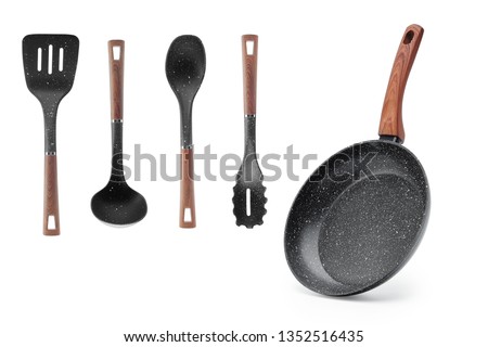 Frying pan wooden handle and a set of four blades, ladle isolate. Kitchen set Gift. Kitchenware