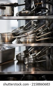 frying pans in a stack on a shelf