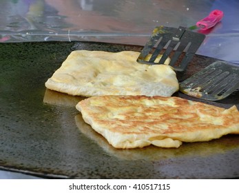 Frying Roti With Cooking Flipper