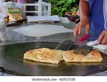 Frying Roti With Cooking Flipper