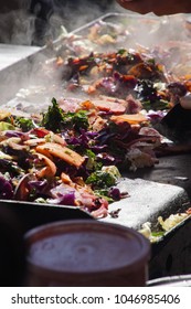 Frying Vegetables On A Grill At The Ballard Farmer's Market On A Spring Day In 
Seattle, Washington