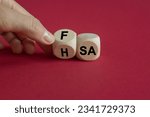FSA or HSA symbol. Turned a cube and changed the word FSA - Flexible Spending Account to HSA - Health Savings Account. Beautiful red background. Business and FSA or HSA concept.