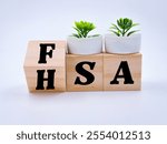 "FSA" and "HSA" words written over wooden cubes 