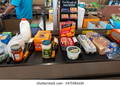 Ft. Pierce,FL/USA-810/19: An Overview Of Groceries Lined Up On A Conveyor Belt At The Check Out Counter Of An Aldi Store.