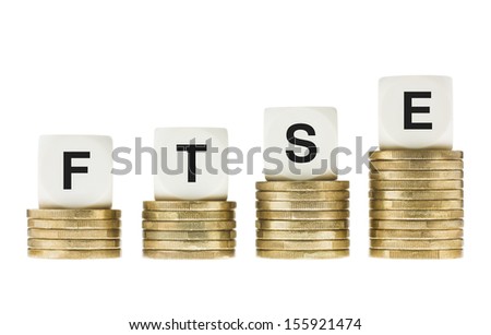 FTSE 100 (London Stock Exchange Share Index) on Gold Coin Stacks Isolated on White