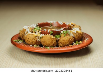 Fuchka or pani puri and gol gappay with sour water, served in dish isolated on table top view of indian, bangladeshi and pakistani street food