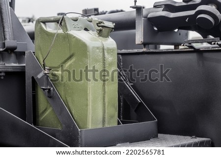 fuel canisters are fixed on the body of a military vehicle