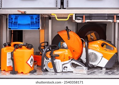 Fuel containers, safety gear, chainsaws organized on metal shelf, prepared for professional outdoor work equipment concept - Powered by Shutterstock