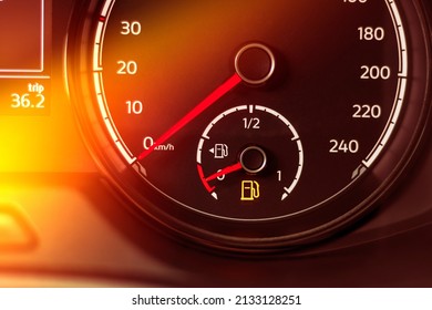 Fuel discharge warning light on the dashboard of the car. The low fuel level is displayed on the dashboard of the speedometer - Powered by Shutterstock