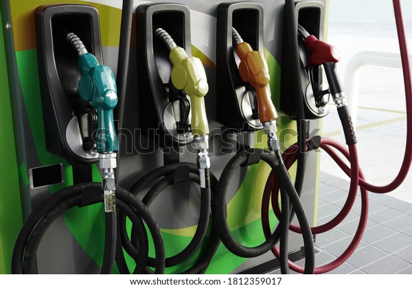 Fuel dispenser machine. Petrol pump filling fuel nozzle\
in gas 