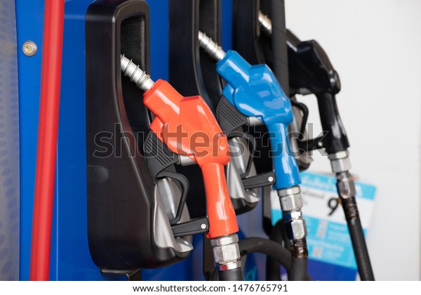 fuel dispenser or nozzle for filli\
oil to car at petroleum station, refill oil fuel. concept : Use of\
mobile phones at petrol stations do not cause\
fires.