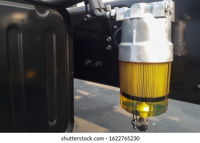 A Fuel Filter In A Truck. Diesel Can Be Seen In The Filter. Closeup View.