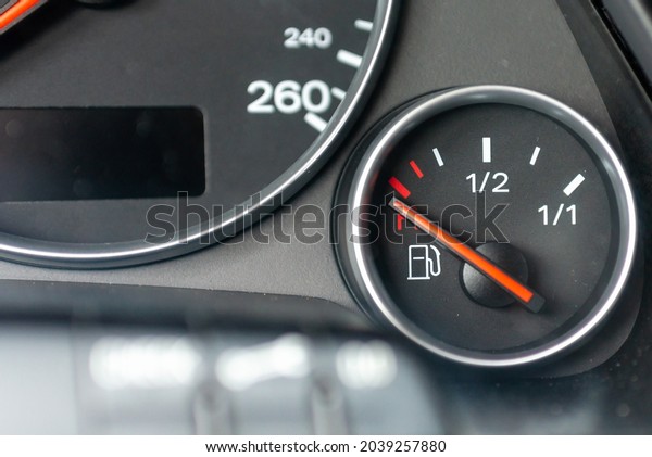 Fuel gauge with red indicator at
empty level.Close-up car dash board petrol meter, fuel gauge, with
over full gasoline in car. Clip.Gasoline
sensor