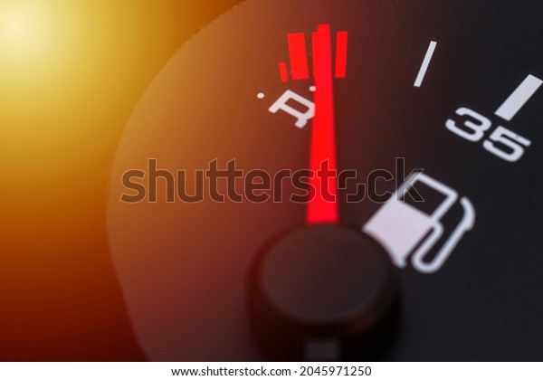 Fuel gauge with red indicator at\
empty level.Close-up car dash board petrol meter, fuel gauge, with\
over full gasoline in car. Clip.Gasoline\
sensor