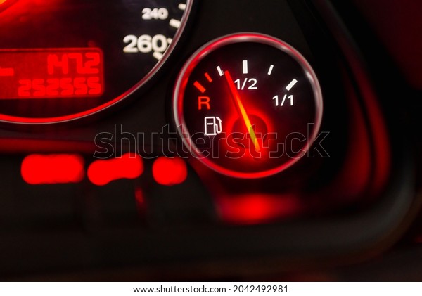 Fuel gauge with speedometer red\
indicator at empty level.Close-up car dash board petrol meter, fuel\
gauge, with over full gasoline in car. Clip.Gasoline\
sensor