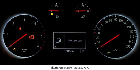 Fuel gauge with warning to indicate low fuel level. Indicator on car dashboard panel. Empty tank of gasoline. Yellow fuel check light. Car cluster with speedometer, tachometer, odometer. - Powered by Shutterstock