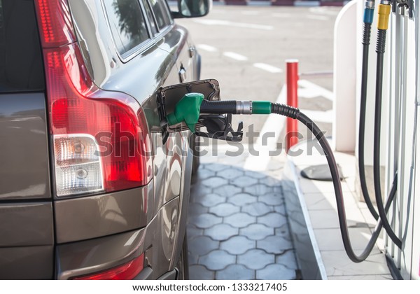 fuel gun in a\
gasoline tank car at a gas\
station