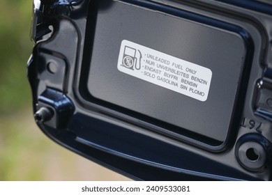 Fuel information sticker inside the filler cap of a new blue vehicle