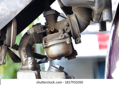 Fuel leaking out of the old carburetor. Common carburetor fuel leaks. Close-up of dirty carburetor in old motorcycle engine. The problem of a carburetor that leaks fuel. Engine repair.