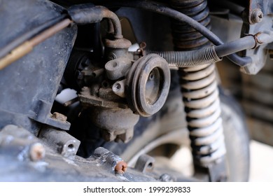 Fuel leaking out of the old carburetor. Common carburetor fuel leaks. Close-up of dirty carburetor in old motorcycle engine. The problem of a carburetor that leaks fuel. Engine repair.