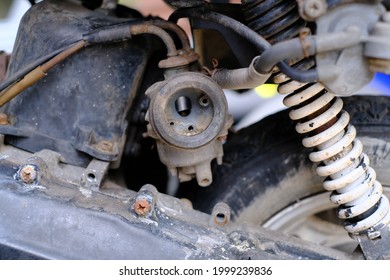 Fuel leaking out of the old carburetor. Common carburetor fuel leaks. Close-up of dirty carburetor in old motorcycle engine. The problem of a carburetor that leaks fuel. Engine repair.