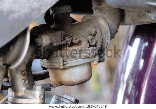Fuel
leaking out of the old carburetor. Common carburetor fuel leaks.
Close-up of dirty carburetor in old motorcycle engine. The problem
of a carburetor that leaks fuel. Engine
repair.
