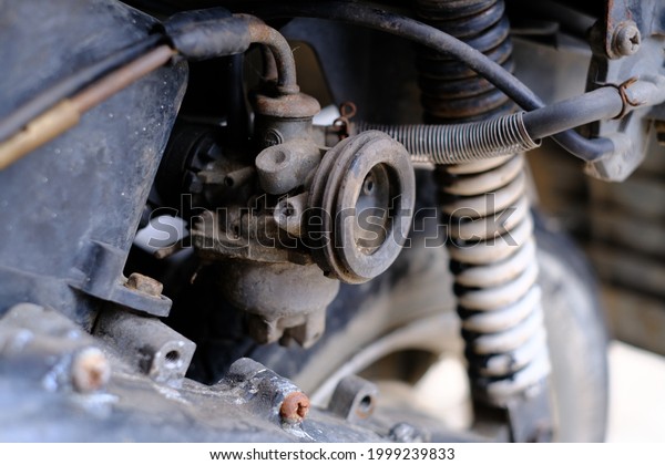 Fuel\
leaking out of the old carburetor. Common carburetor fuel leaks.\
Close-up of dirty carburetor in old motorcycle engine. The problem\
of a carburetor that leaks fuel. Engine\
repair.