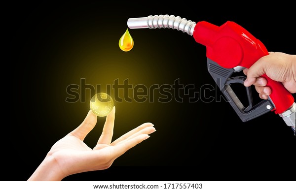 Fuel nozzle Hand holding\
Oil extracted from the Mobile coin Expensive spending background,\
clipingpart