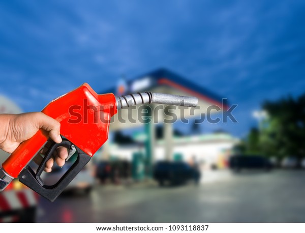 Fuel nozzle\
on the pump it\'s blurred\
background.