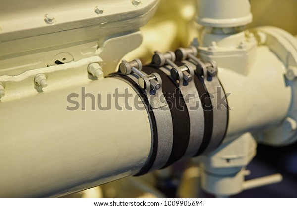 Fuel\
pipes and crimp rubber rings on the engine\
close-up.
