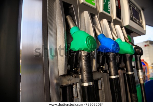 Fuel pistols close up\
at the gas station