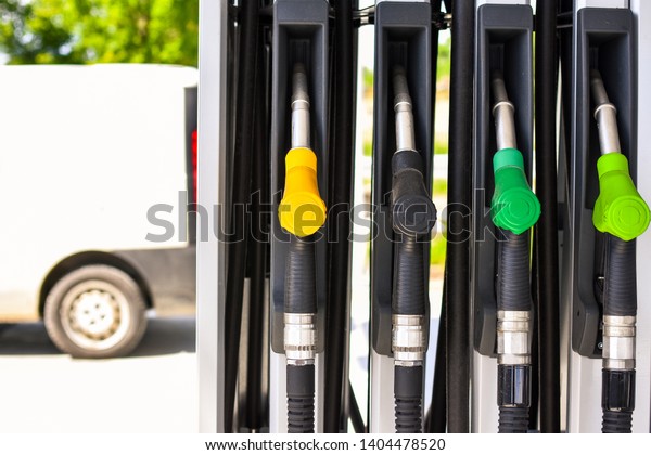 Fuel pumps at a gas station. Gasoline station.\
Colorized fuel pumps.