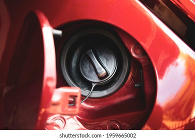 Fuel Tank Door Is Open And Fuel Tank Cap Closed Of The Red Car