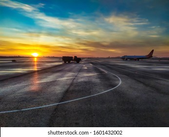 Fuel Tanker On Airstrip At The Sunrise. Runway, Airstrip In The Airport. Travel Aviation Concept.