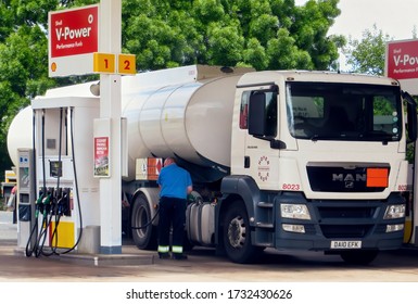 Fuel Tanker Truck Driver Getting Petrol For His Huge Vehicle At Small Gas Station Before Resuming March Toward Airport To Deliver Special Aviation Fuel (1863 Code On Orange Plate). CHEAM, UK -MAY 2015