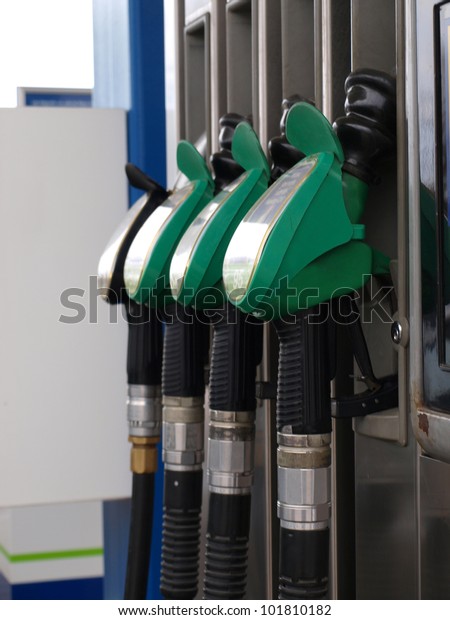 Fuel tanks\
pipes with handles on petrol\
station