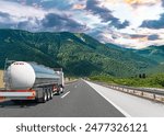 Fuel truck on a picturesque road. A silver tank truck transports fuel.